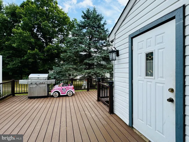 a backyard of a house with barbeque oven and sofas