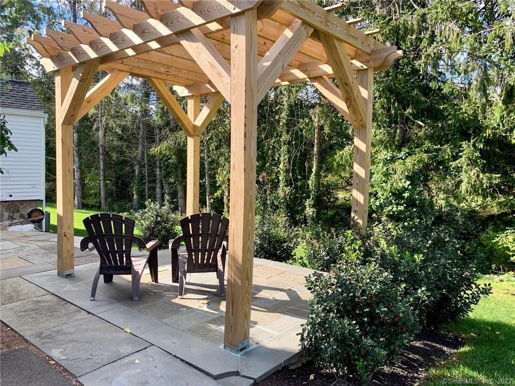 368 Boston Street Guilford, CT 06437 - Photo 14 of 24 a view of a patio with table and chairs and floor to ceiling window