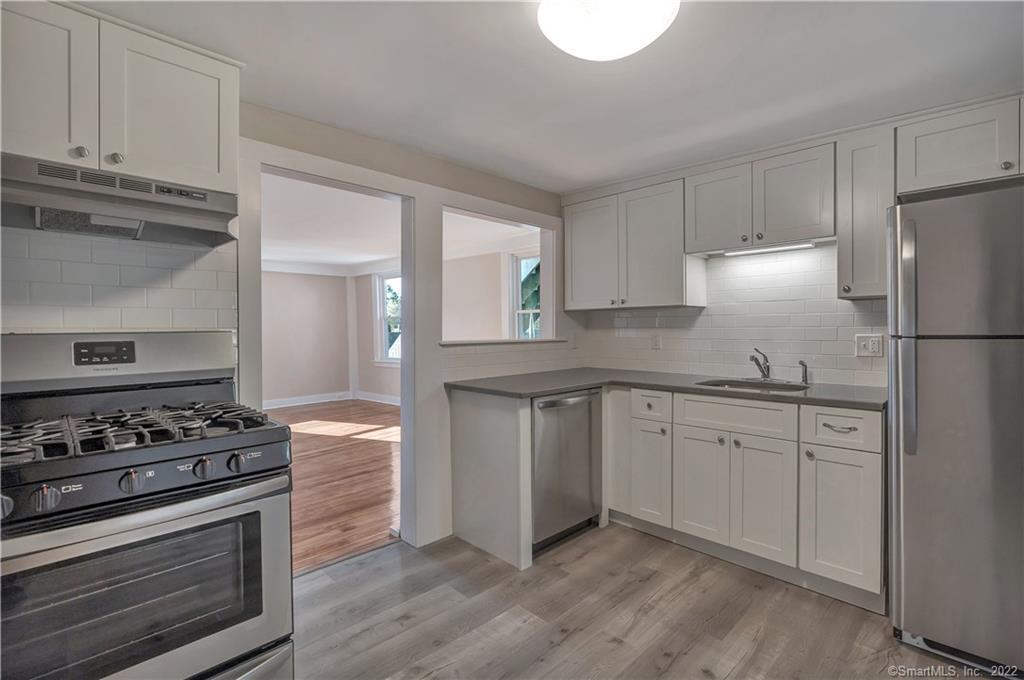 368 Boston Street Guilford, CT 06437 - Photo 3 of 24 a kitchen with granite countertop cabinets and steel stainless steel appliances