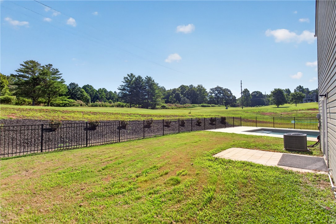 2007 Aberdeen Lane Walhalla, SC 29691 - Photo 31 of 41 A fenced backyard retreat offers serene views of a golf course and a refreshing pool.