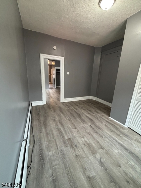 108 Pine Street, Unit 1 Montclair, NJ 07042 - Photo 9 of 9 a view of an empty room with wooden floor and a window