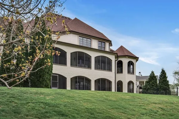 a view of a dining room with furniture and a chandelier