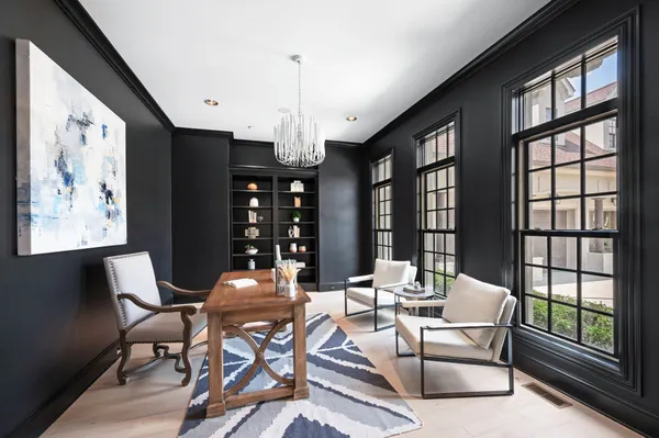 a living room with furniture and large windows