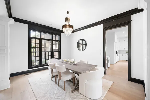 a large kitchen with kitchen island a large counter top space a sink stainless steel appliances and cabinets