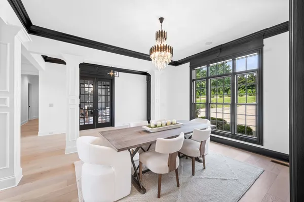 a kitchen with granite countertop a sink and white cabinets