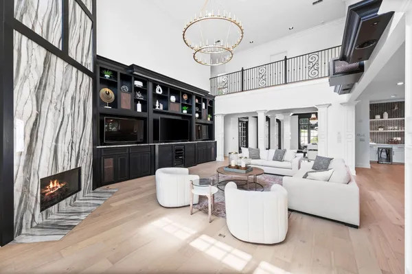 a view of a patio with a couple of chairs and a barbeque