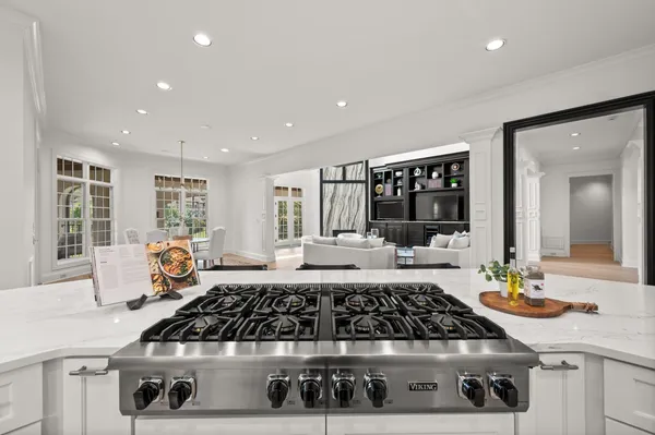 a large bathroom with a large tub sink and mirror