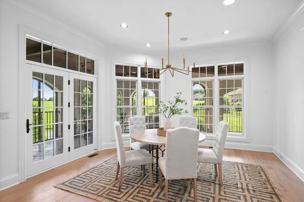 an empty room with wooden floor and ceiling fan