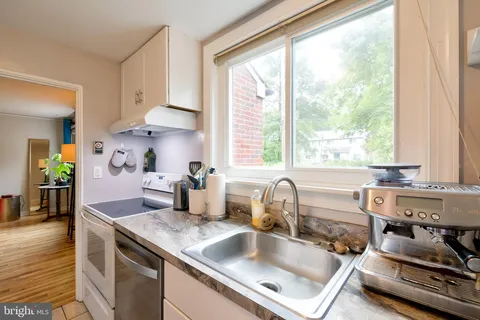 a kitchen with kitchen island a sink stove and cabinets