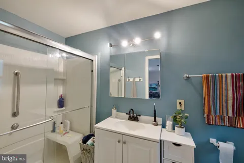 a bathroom with a sink toilet and mirror