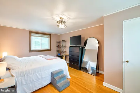 a bed room with a bed and a television