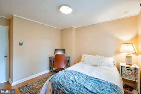 a bedroom with a bed and a lamp