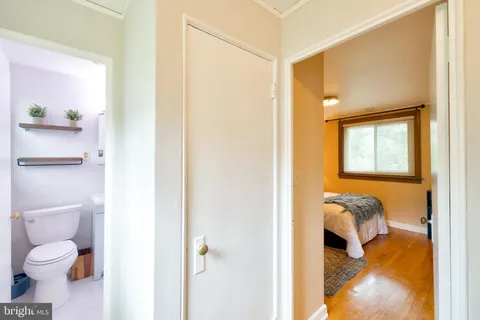 a bathroom with a granite countertop toilet and a shower