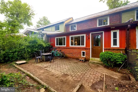 front view of a brick house with a yard
