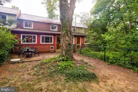 a front view of a house with yard and green space