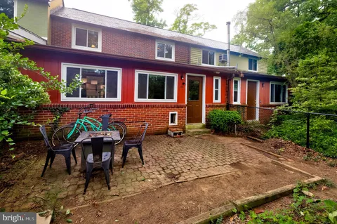 a view of a brick building with a bench in patio