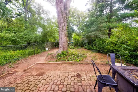 a wooden bench sitting in the middle of a garden