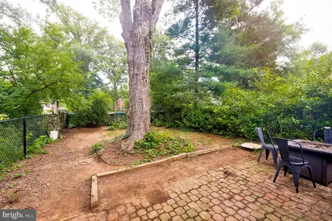 a backyard of a house with table and chairs