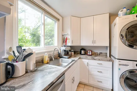 a kitchen that has a sink a stove and a window