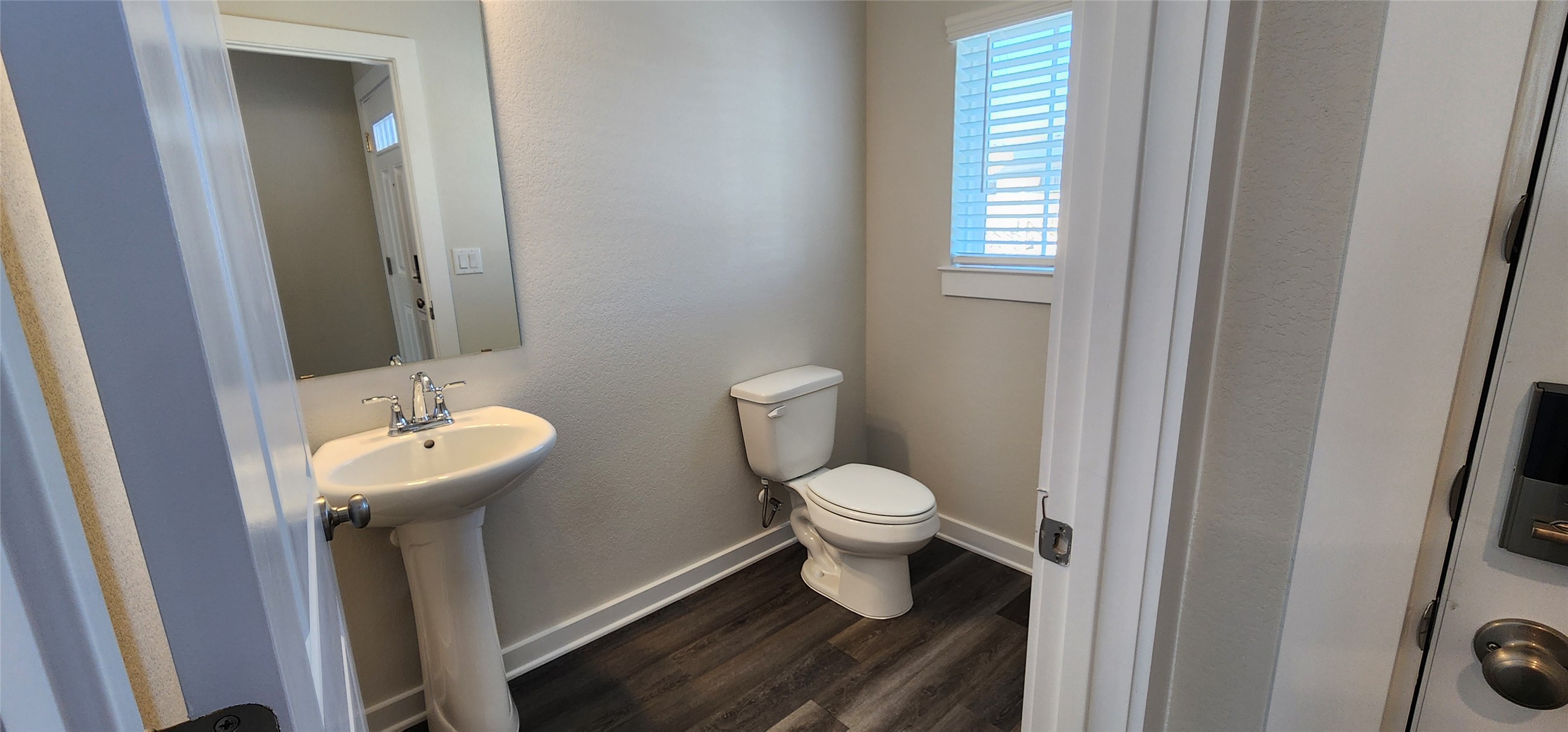 2240 Delano Drive Leander, TX 78641 - Photo 3 of 32 Half bath with dark wood finished floors and a textured wall