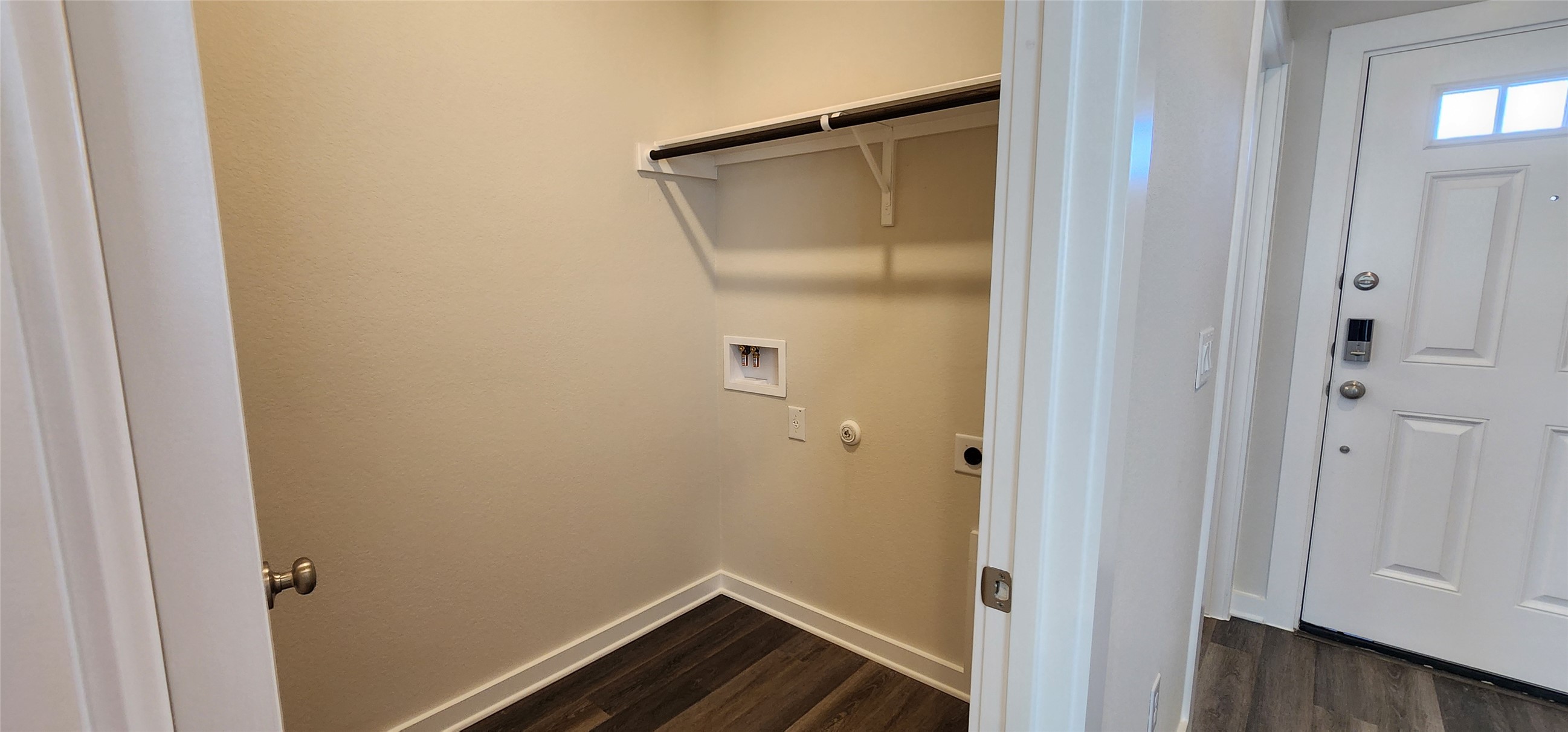 2240 Delano Drive Leander, TX 78641 - Photo 4 of 32 Laundry room featuring dark wood-style floors, washer hookup, and hookup for an electric dryer