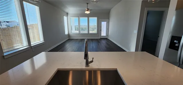 a view of wooden floor and windows in an empty room