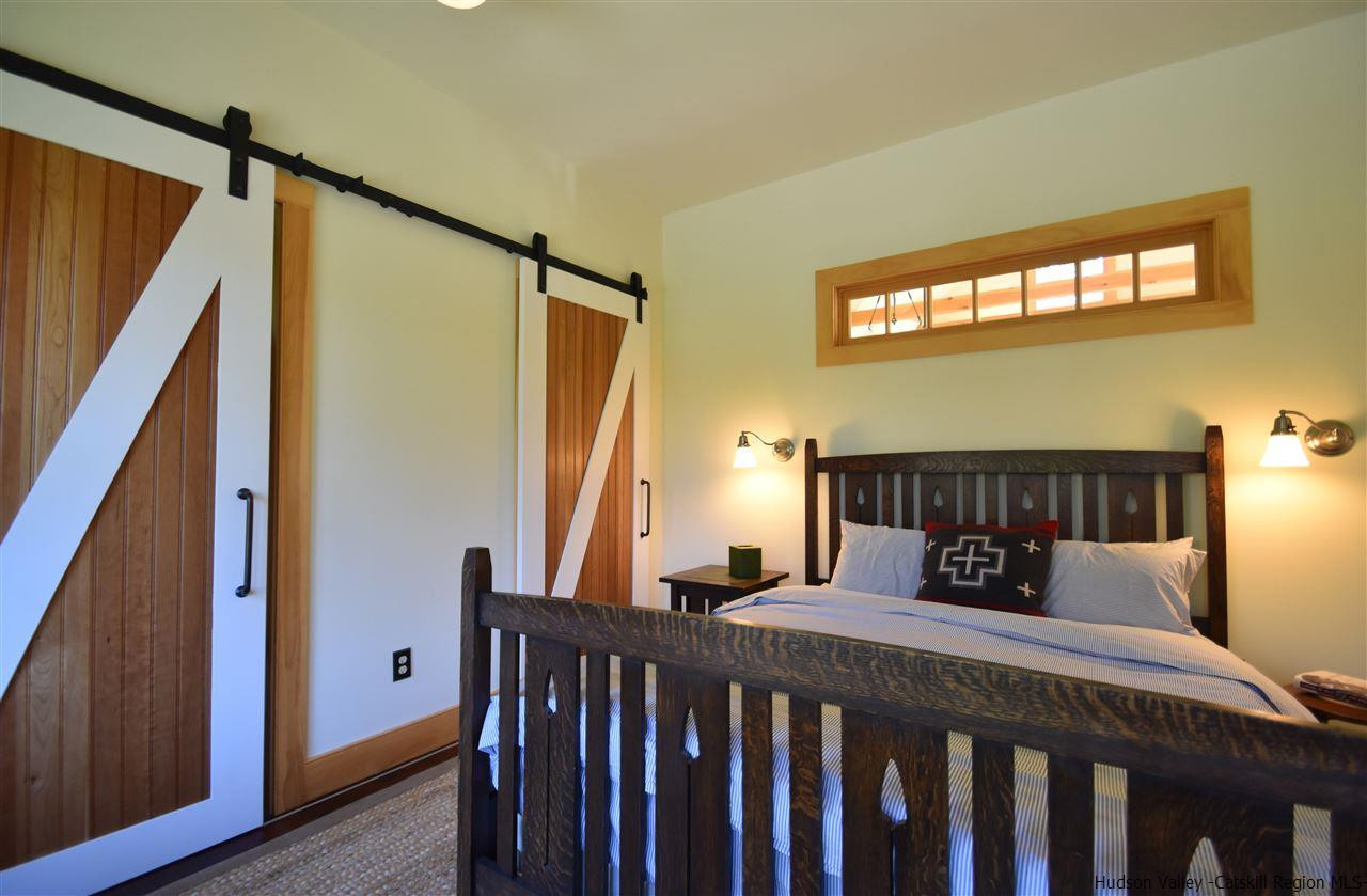 555 Milan Hill Road Red Hook, NY 12571 - Photo 22 of 29 a bedroom with a bed next to a window