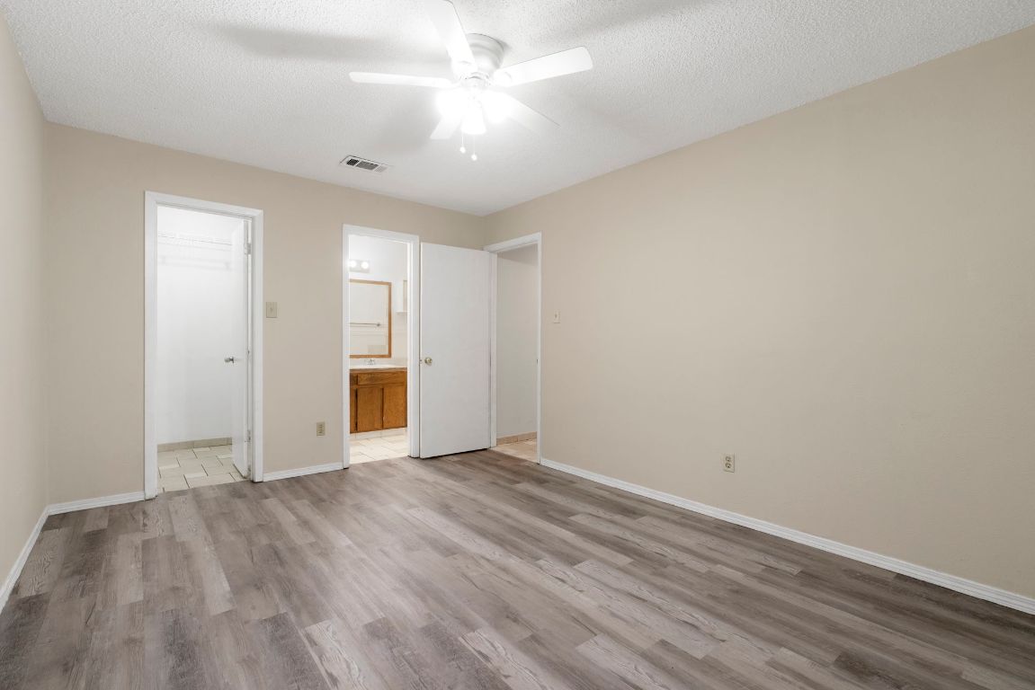 7703 Peaceful Hill Lane, Unit B Austin, TX 78745 - Photo 13 of 22 a view of an empty room with wooden floor