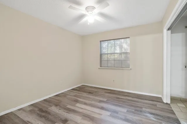 wooden floor in an empty room with a window