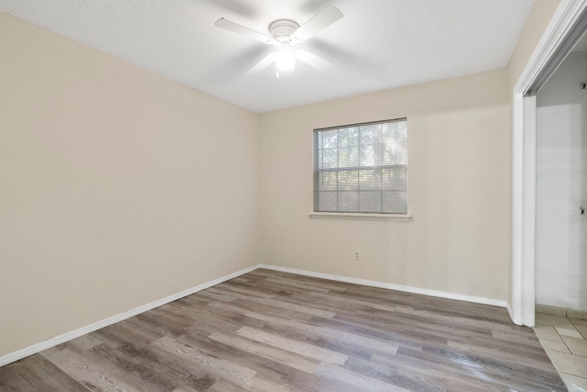 7703 Peaceful Hill Lane, Unit B Austin, TX 78745 - Photo 15 of 22 wooden floor in an empty room with a window