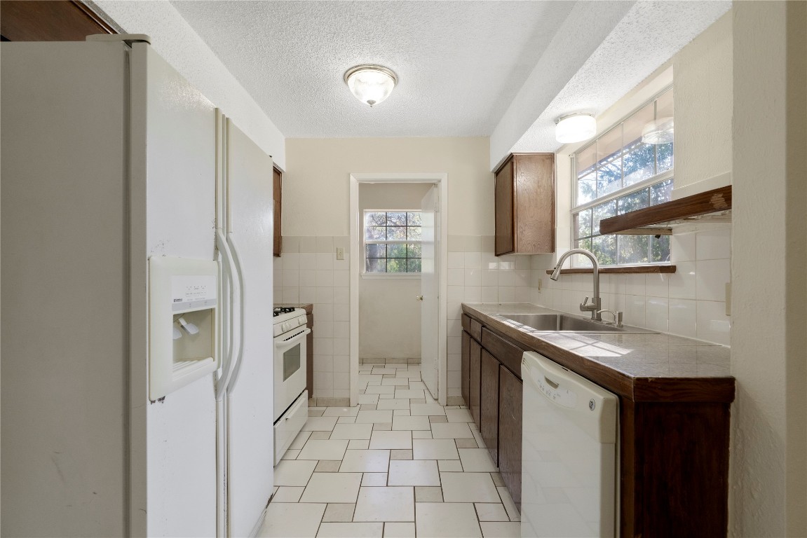 7703 Peaceful Hill Lane, Unit B Austin, TX 78745 - Photo 2 of 22 a kitchen with a sink stove and refrigerator