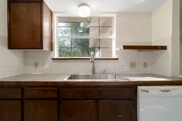 a kitchen with a sink and cabinets