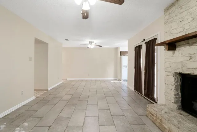 a view of an empty room with a fireplace
