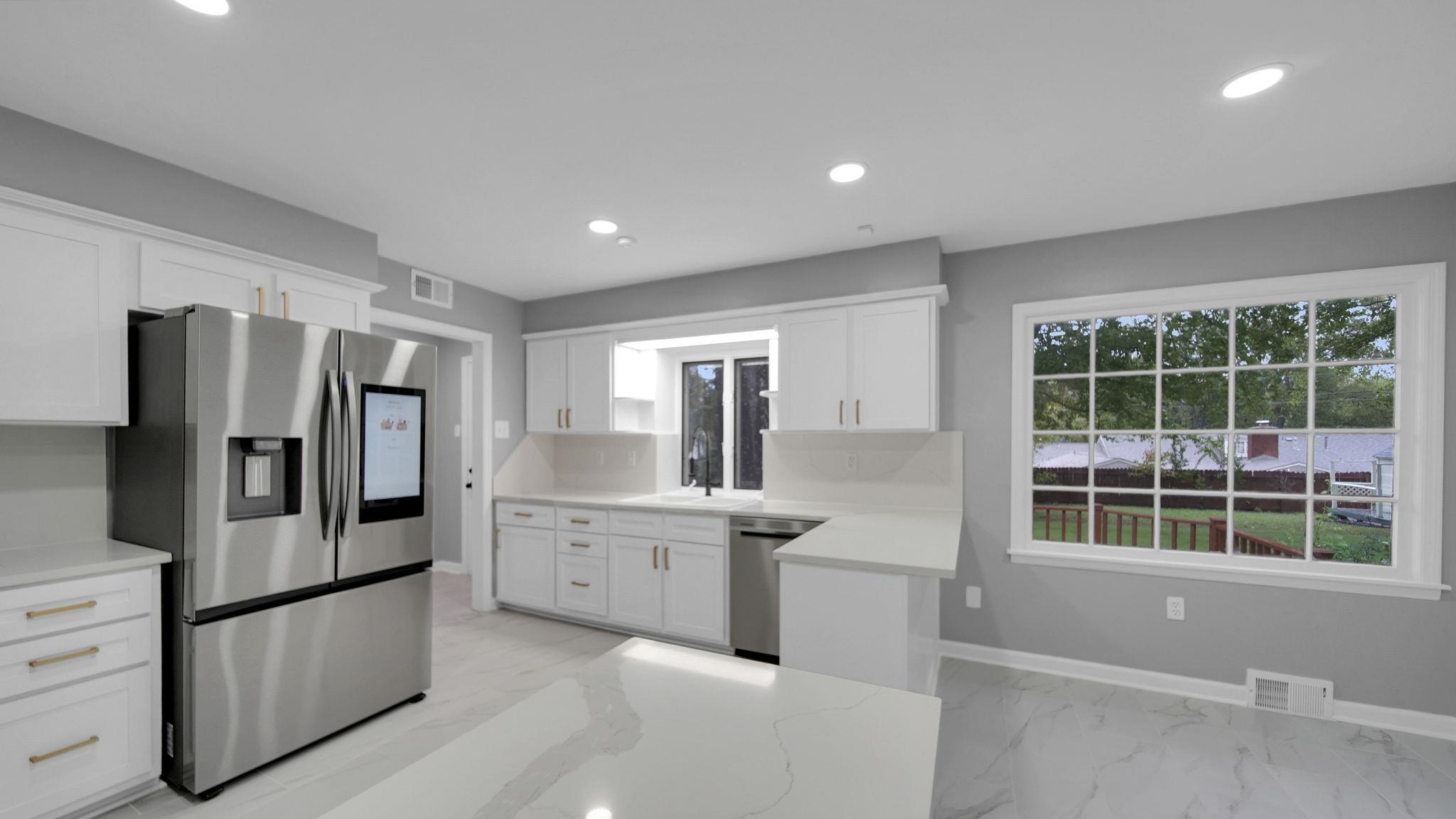 5256 Collingwood Road Memphis, TN 38117 - Photo 14 of 40 Kitchen with stainless steel appliances, white cabinetry, recessed lighting, and light marble finish flooring