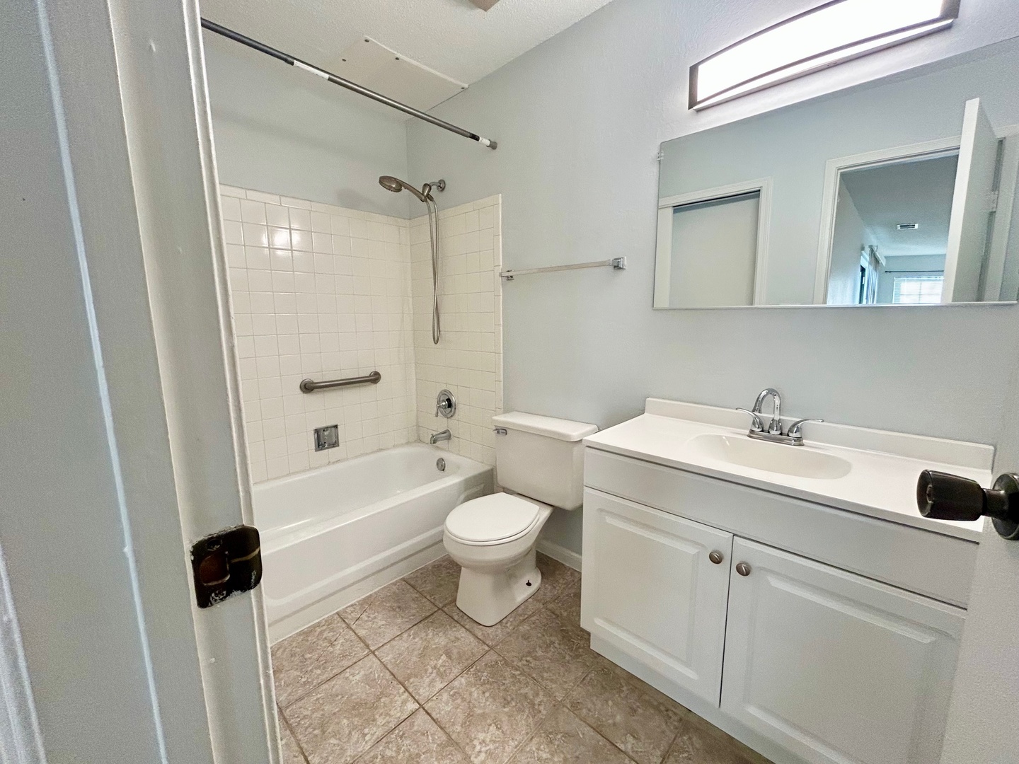2068 North Rand Road, Unit 109 Palatine, IL 60074 - Photo 7 of 9 a bathroom with a toilet sink a mirror a bathtub and shower