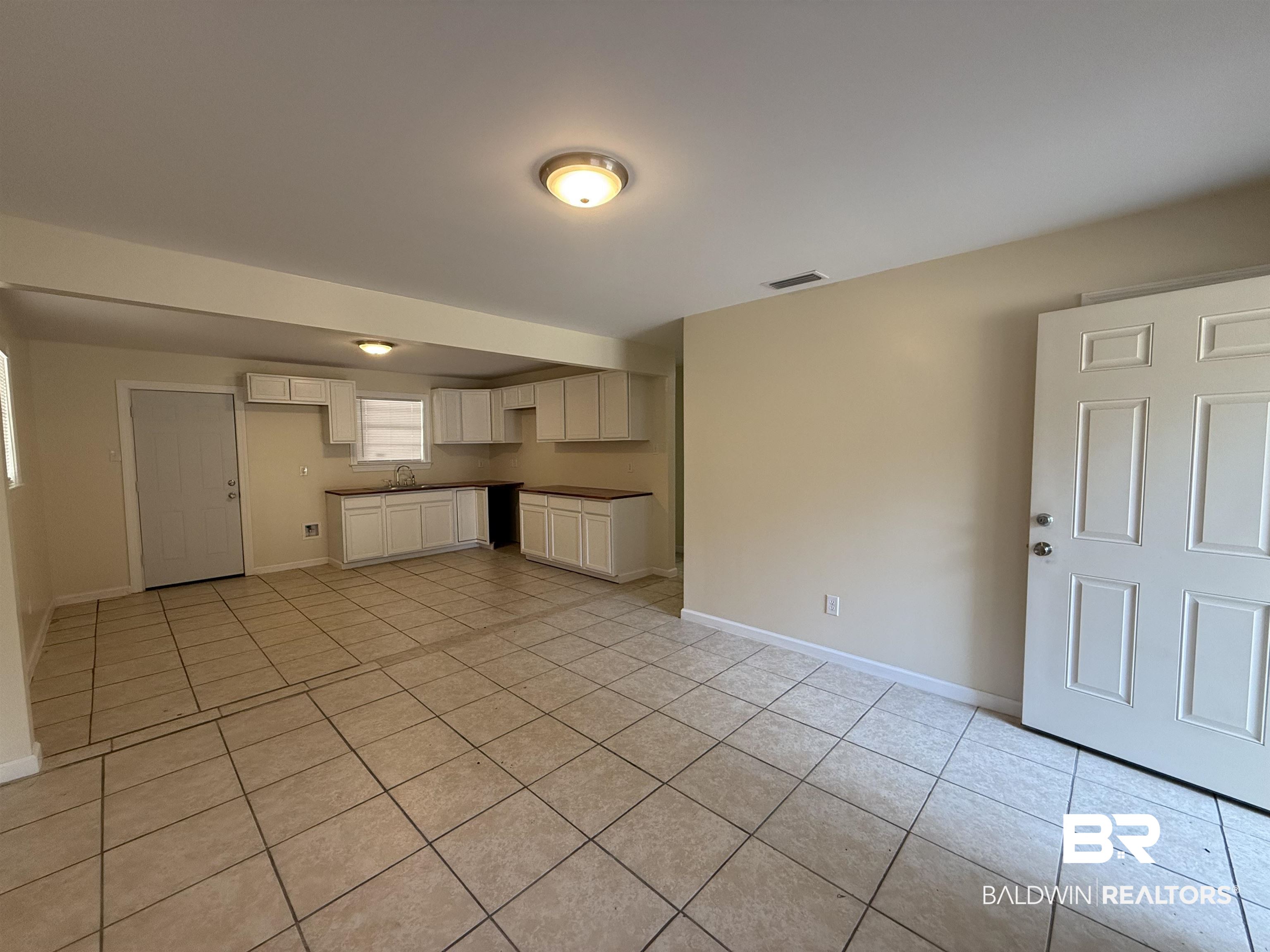 320 E Street Prichard, AL 36610 - Photo 3 of 16 Unfurnished living room featuring light tile patterned floors