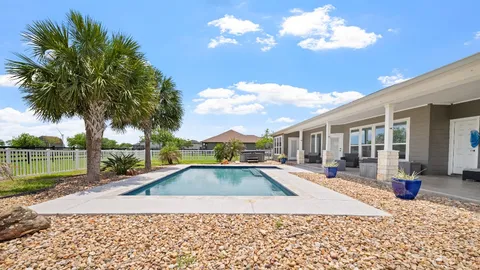 a view of a house with swimming pool and sitting area
