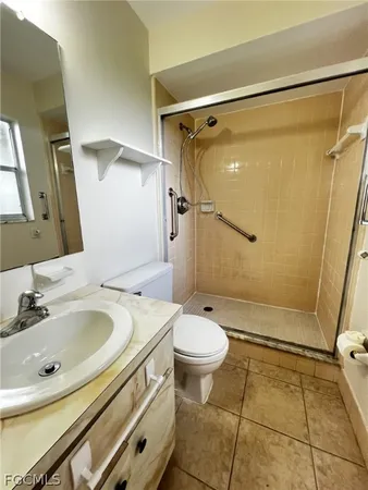 a bathroom with a sink mirror vanity and toilet