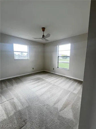 an empty room with a empty space and windows