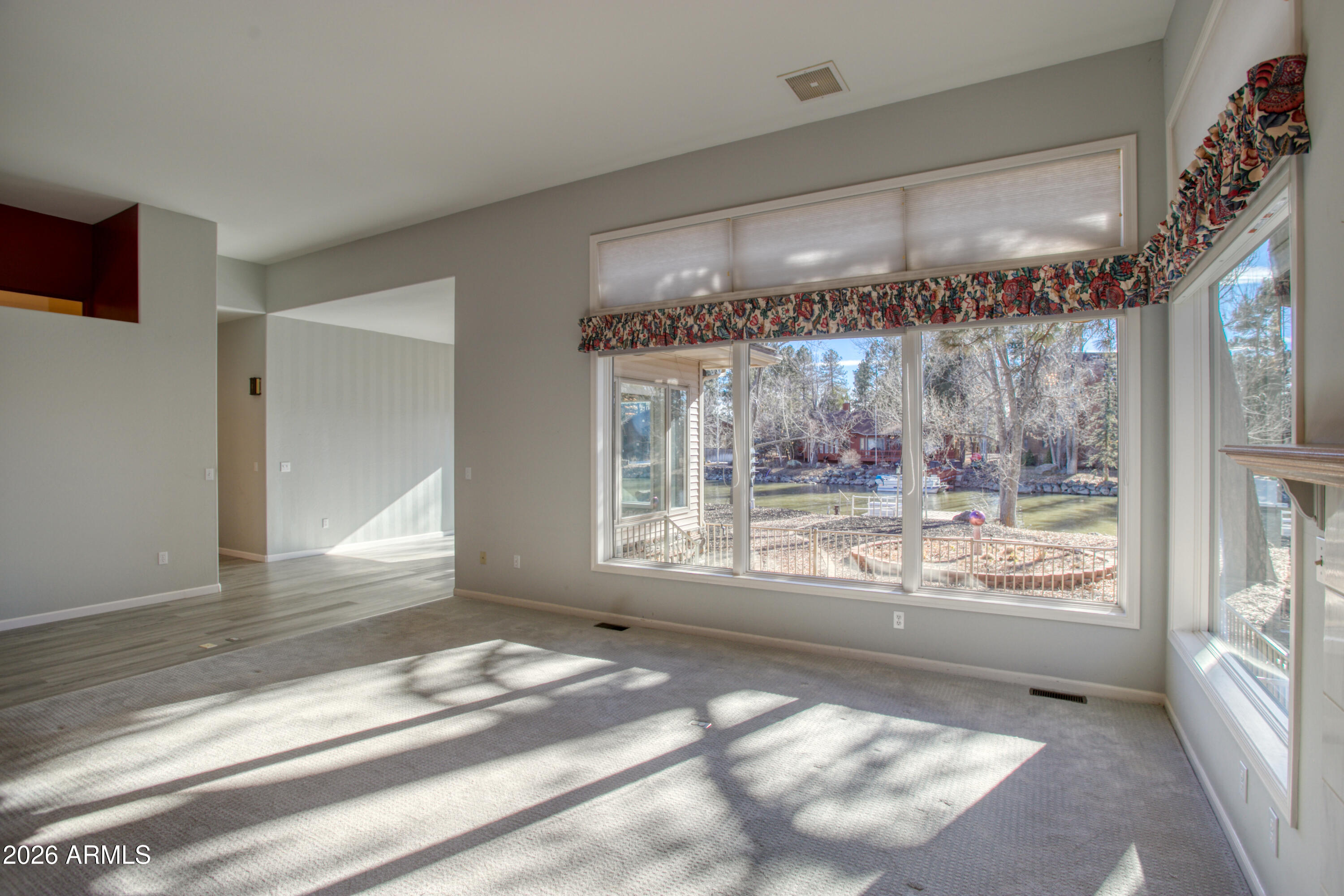 2457 Dragonfly Lane Pinetop-Lakeside, AZ 85929 - Photo 11 of 35 a view of a big room with wooden floor and outdoor space