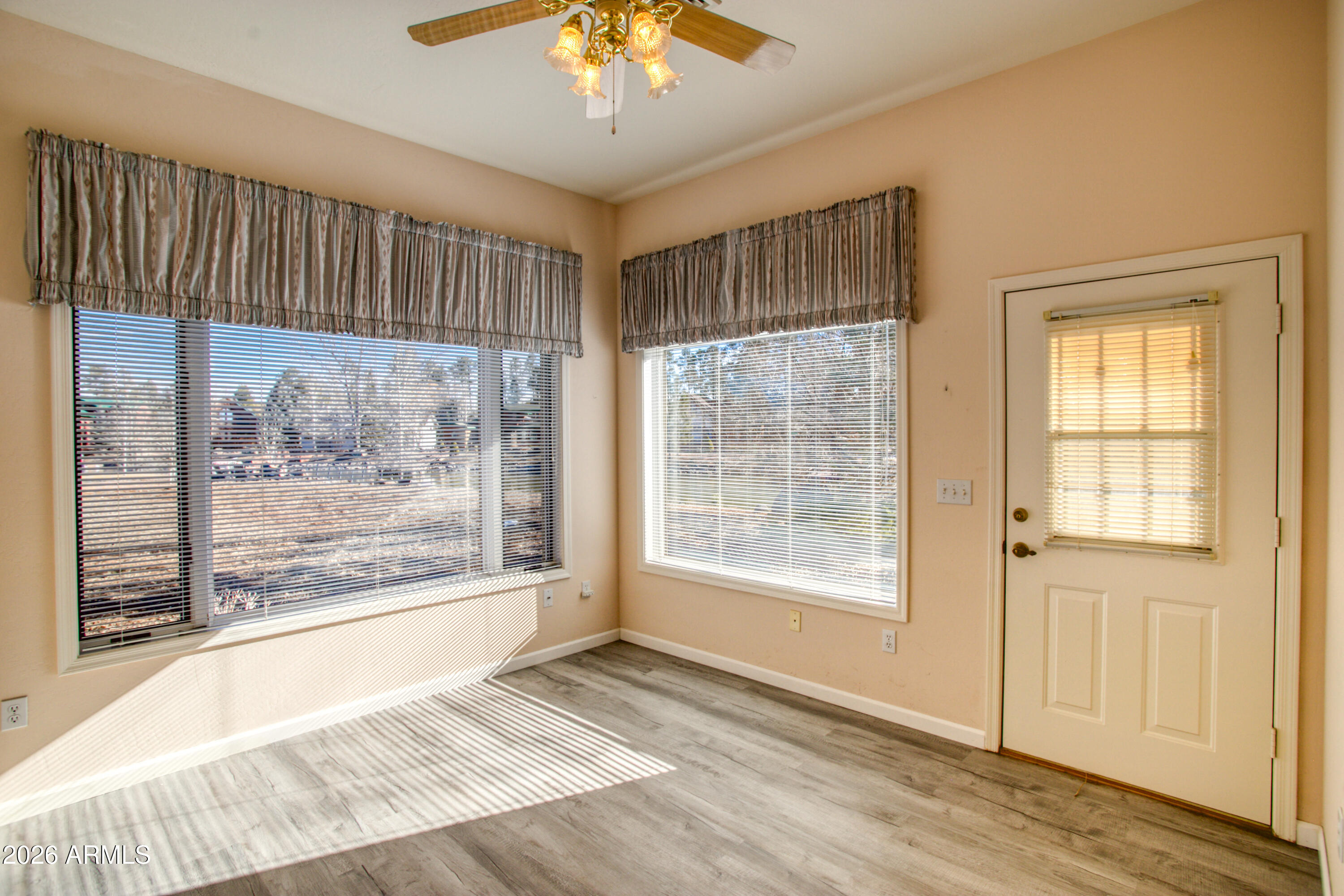 2457 Dragonfly Lane Pinetop-Lakeside, AZ 85929 - Photo 27 of 35 a view of an empty room with wooden floor and a window