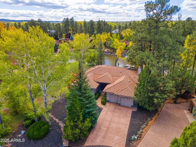 an aerial view of a house with swimming pool and garden