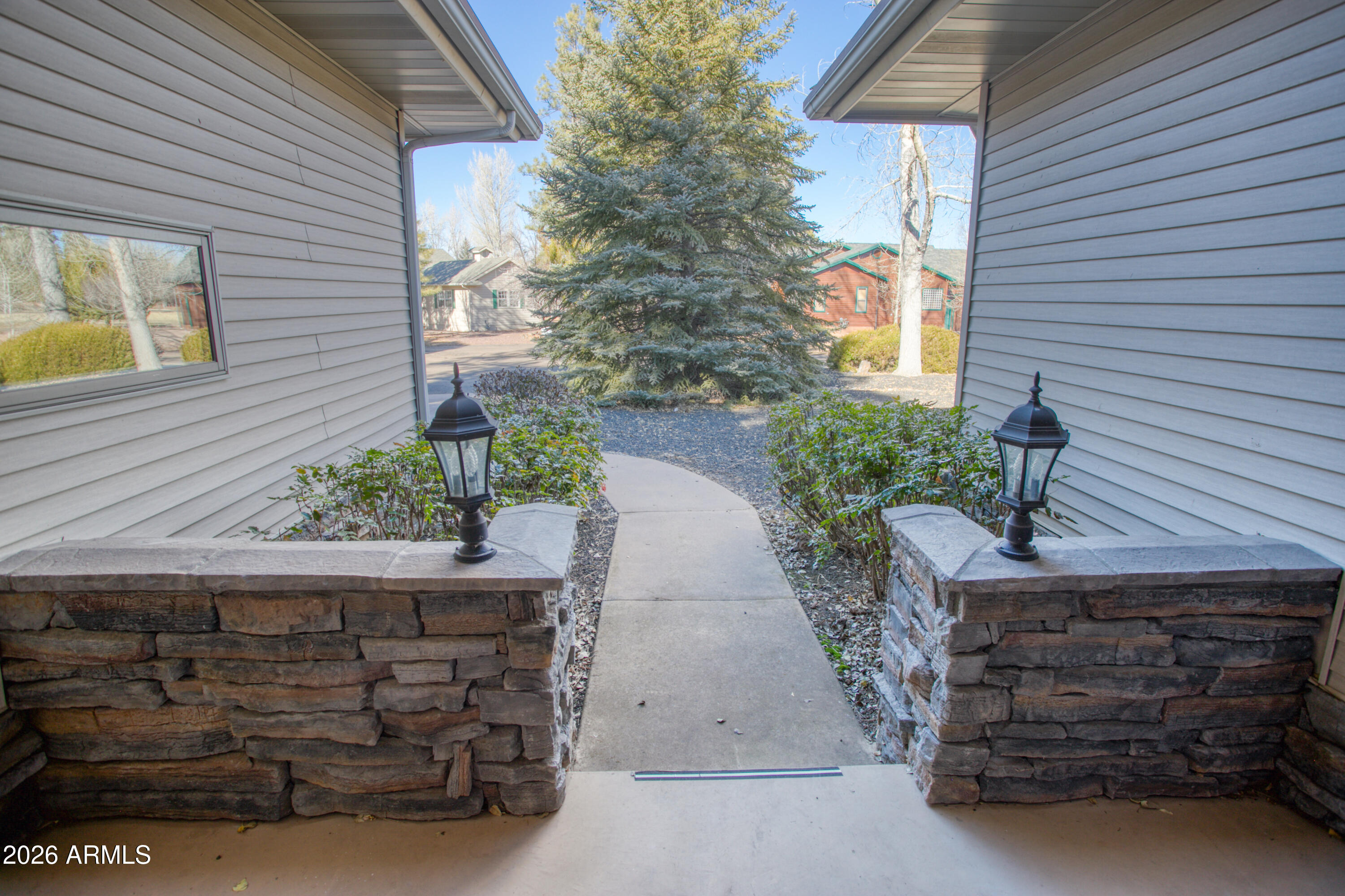 2457 Dragonfly Lane Pinetop-Lakeside, AZ 85929 - Photo 31 of 35 a front view of a house with a garden