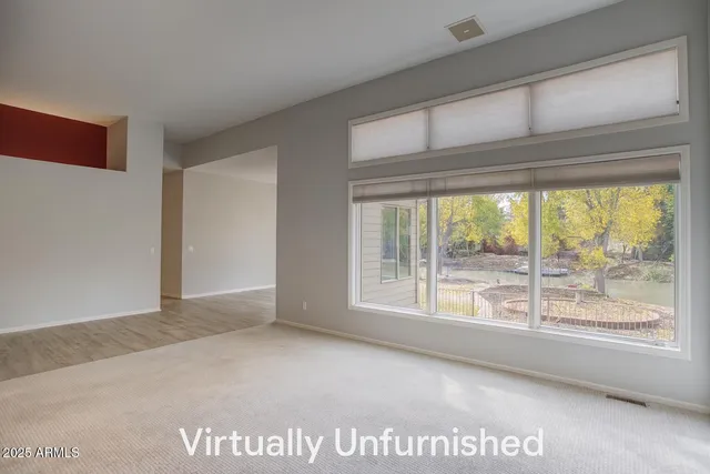 a bedroom with furniture and large windows