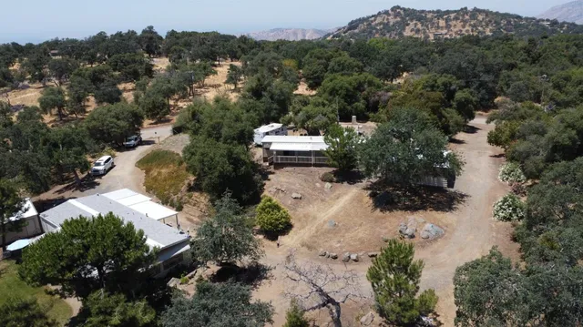 an aerial view of a house with yard
