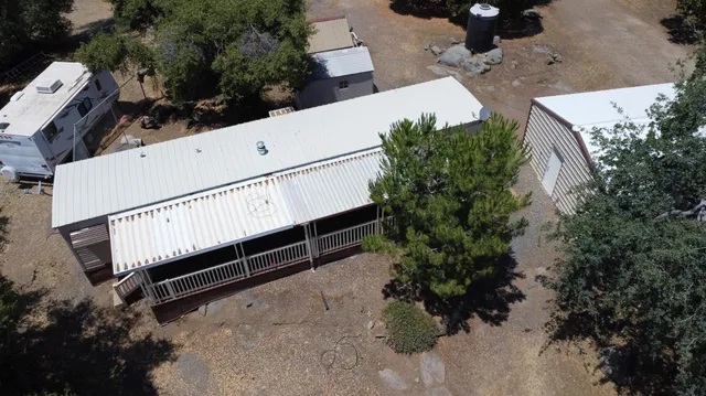 a view of a patio with table and chairs under an umbrella