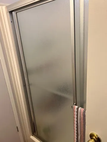 a bathroom with a toilet and a shower