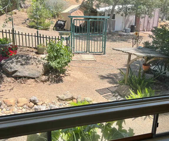 a view of a swimming pool with a patio and a yard