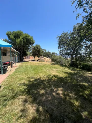 a view of a house with a yard covered in snow