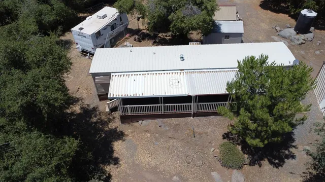 an aerial view of a house with a yard